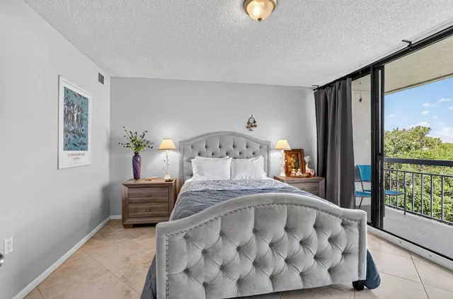 a large bed sitting in a bedroom next to a window