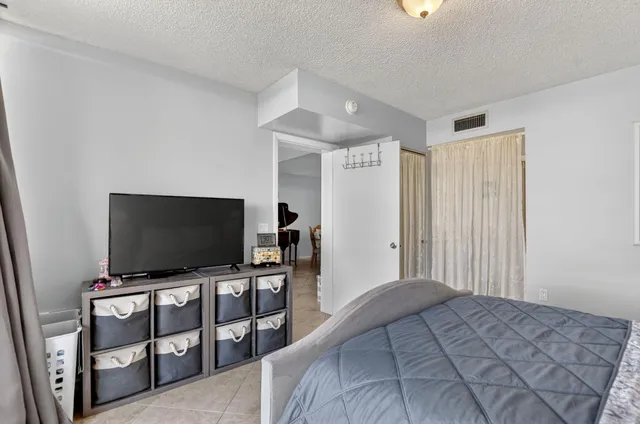 a bedroom with furniture and flat screen tv
