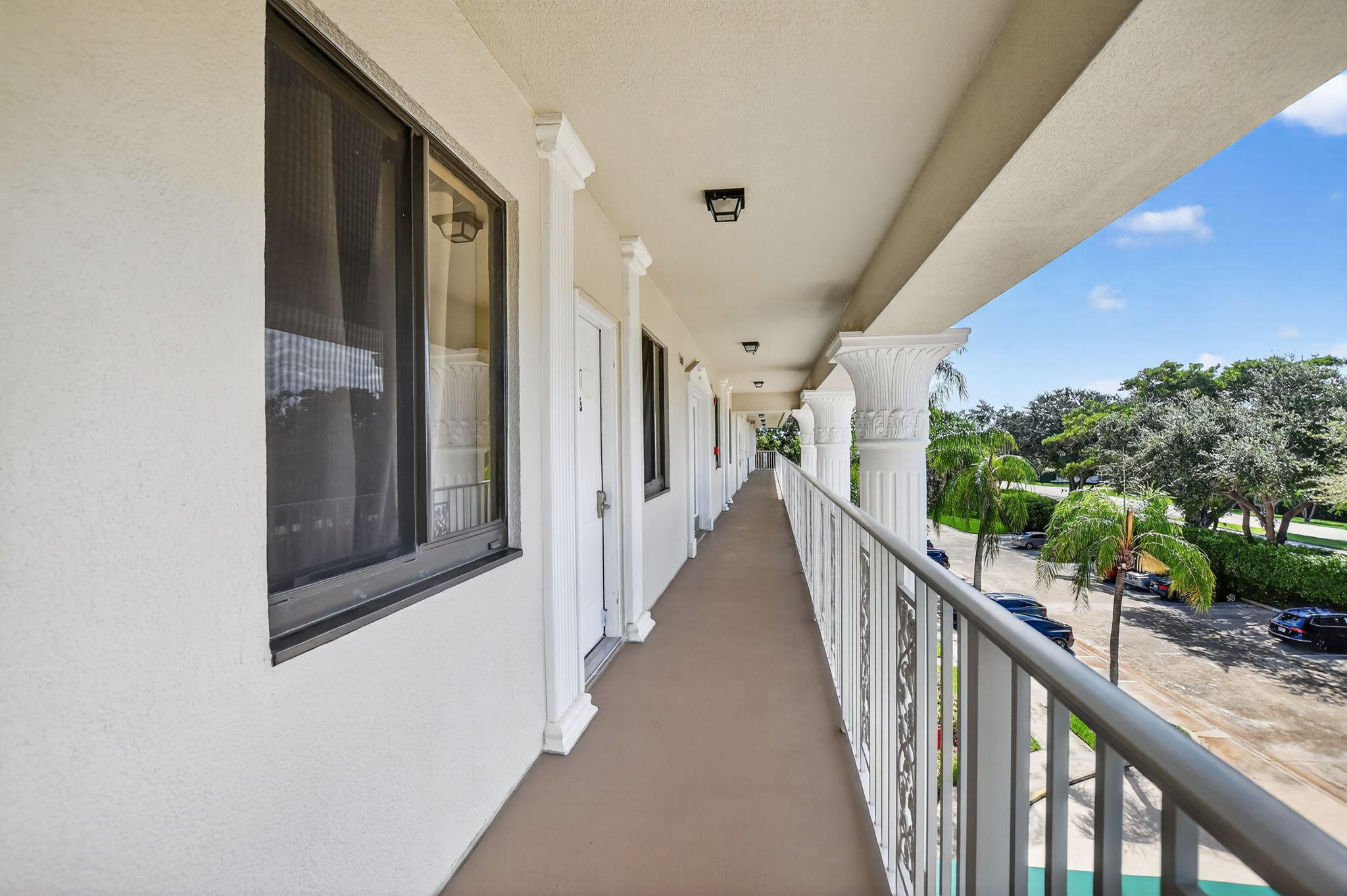 6205 Balboa Circle, Unit 403 Boca Raton, FL 33433 - Photo 2 of 41 a view of a hallway with wooden floor and stairs