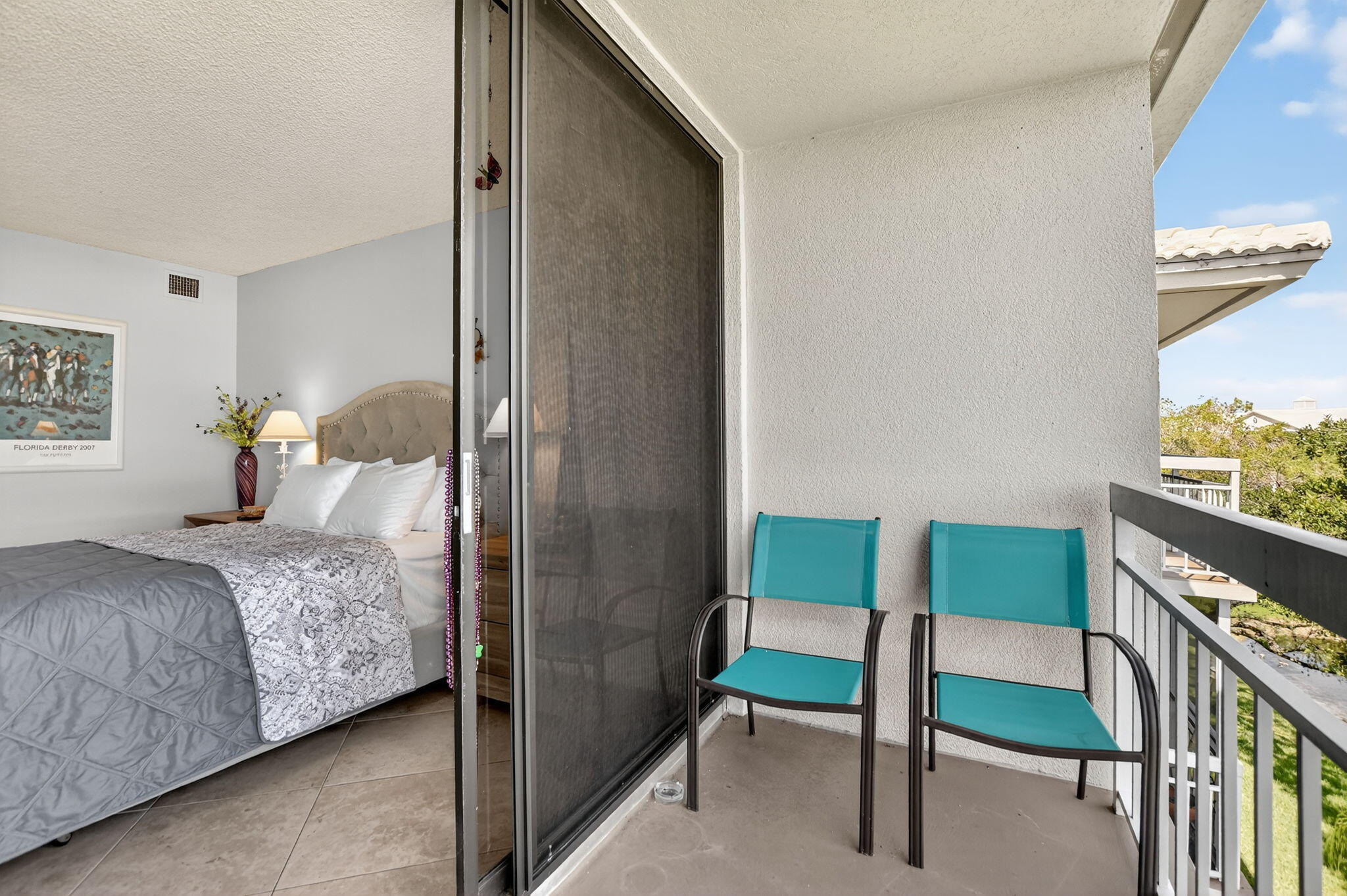 6205 Balboa Circle, Unit 403 Boca Raton, FL 33433 - Photo 24 of 41 a bedroom with a bed and a dresser