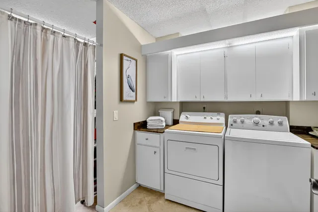 a view of storage and utility room with closet dryer and washer