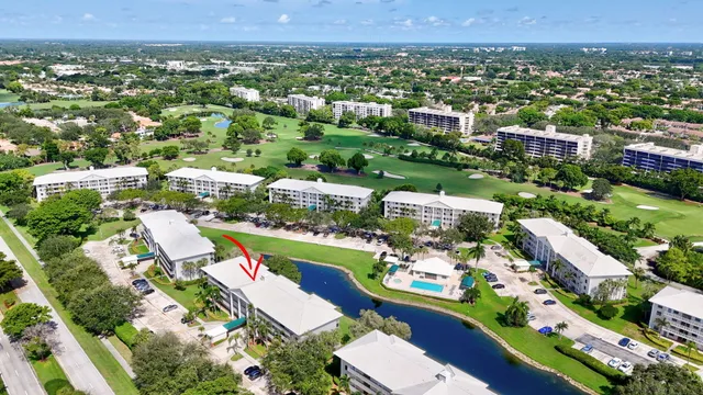 an aerial view of a city with lots of residential buildings and mountain view in back