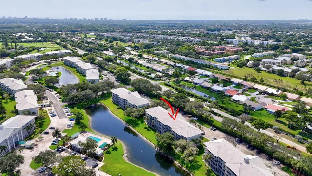 an aerial view of a city with lots of residential buildings and mountain view in back