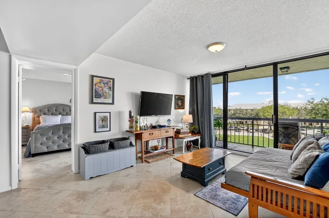 a living room with furniture and large flat screen tv