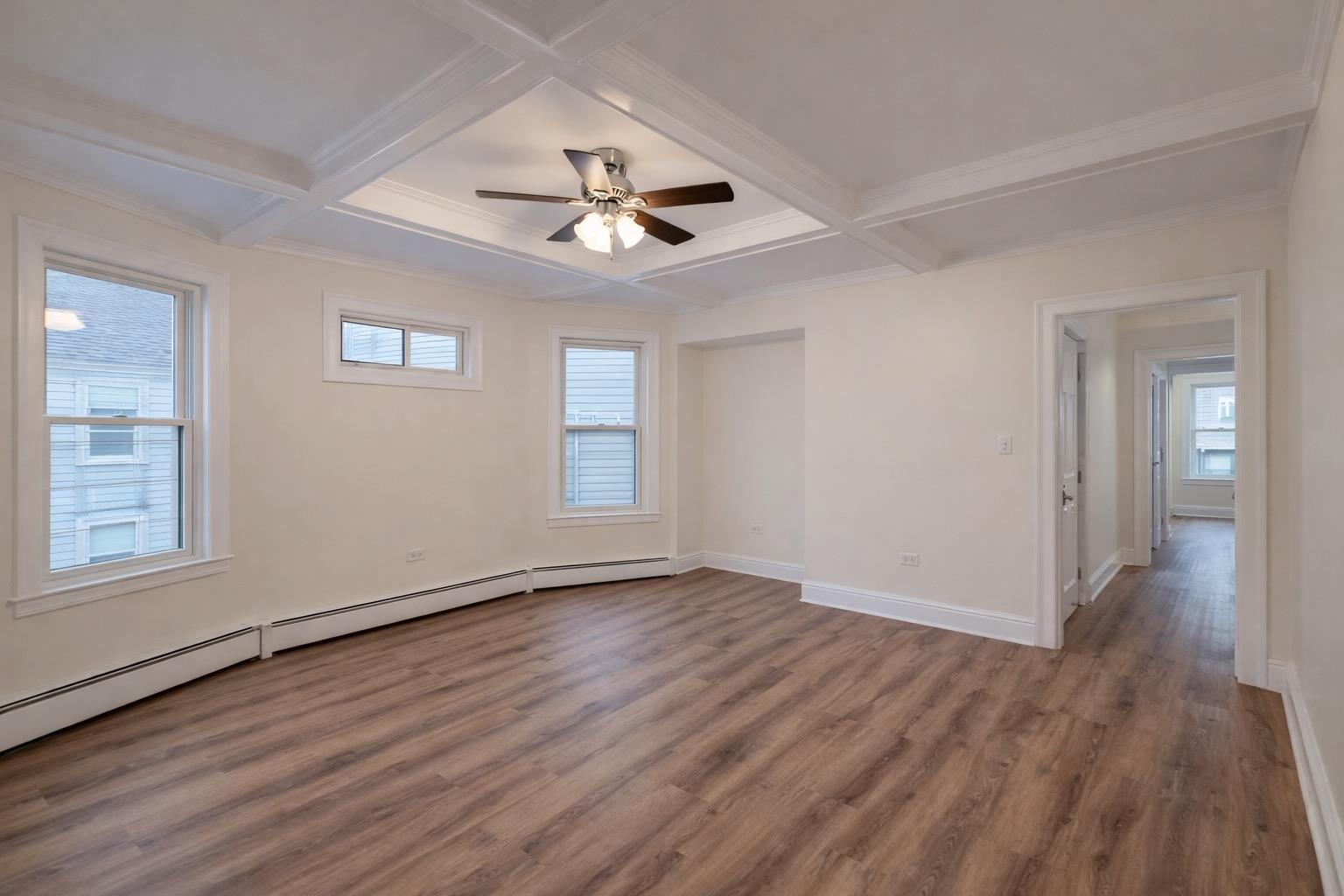 64 South 13th Street, Unit 3 Newark, NJ 07107 - Photo 5 of 8 a view of an empty room with wooden floor and a window