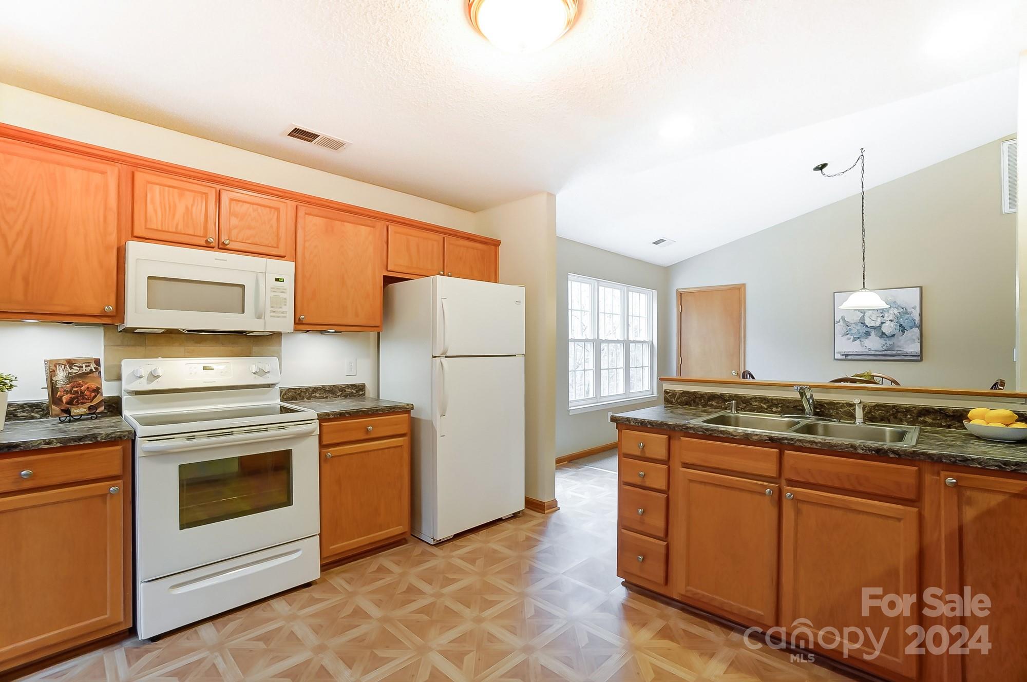 5312 Addison Road Waxhaw, NC 28173 - Photo 12 of 48 a kitchen with stainless steel appliances granite countertop a stove a sink dishwasher and a refrigerator