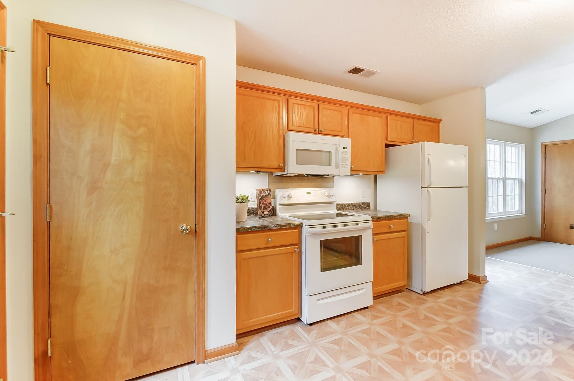 5312 Addison Road Waxhaw, NC 28173 - Photo 13 of 48 a kitchen with stainless steel appliances a refrigerator and a stove