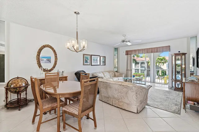 a dining room with furniture a chandelier and a rug