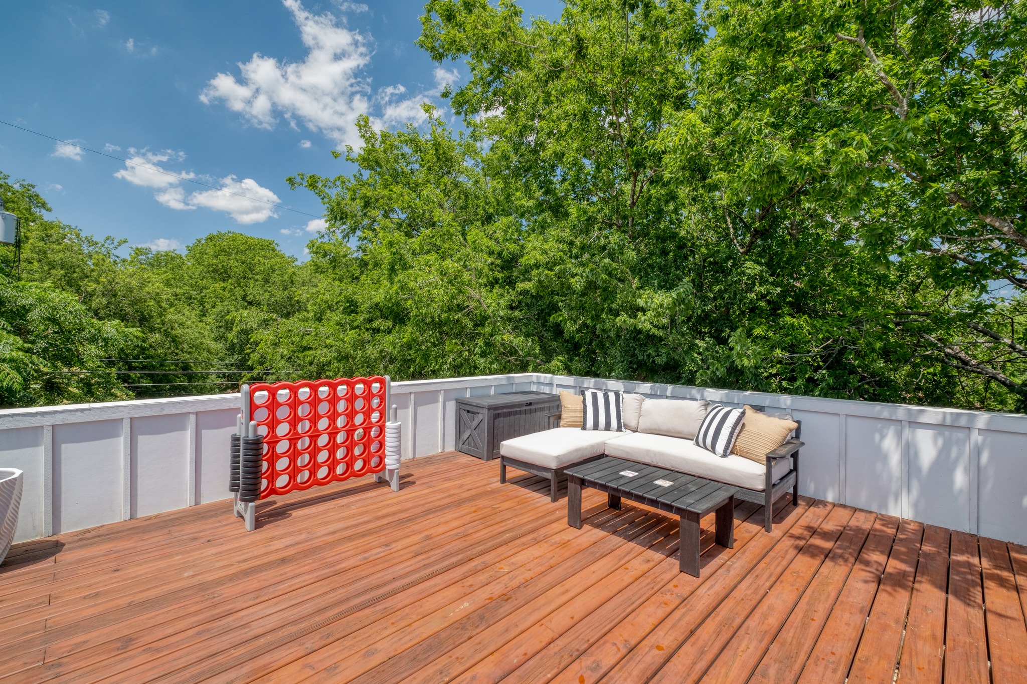 1904 East 16th Street, Unit 2 Austin, TX 78702 - Photo 18 of 20 Spacious wood deck featuring white privacy walls and lush treetop surroundings