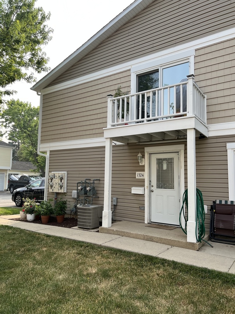 1324 Alpine Court, Unit 1324 Wheeling, IL 60090 - Photo 1 of 1 a front view of a house with a yard