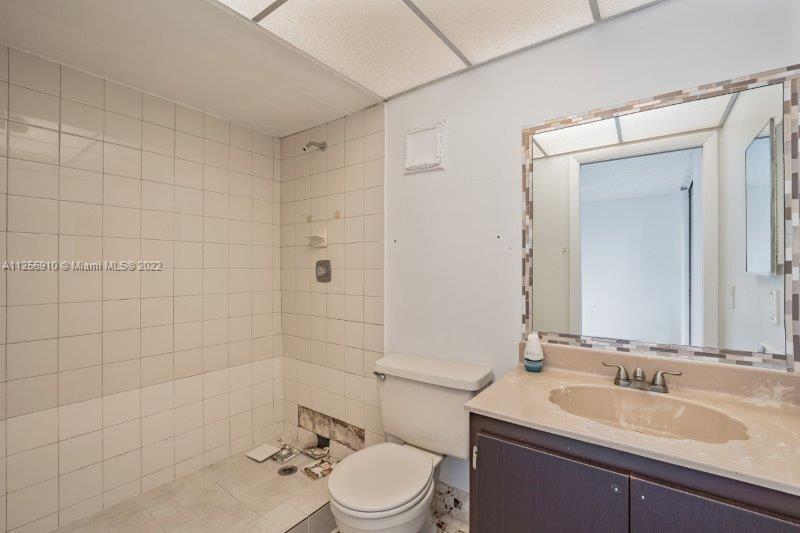 8540 Southwest 133rd Avenue Road, Unit 208 Miami, FL 33183 - Photo 18 of 18 a bathroom with a sink a toilet and shower