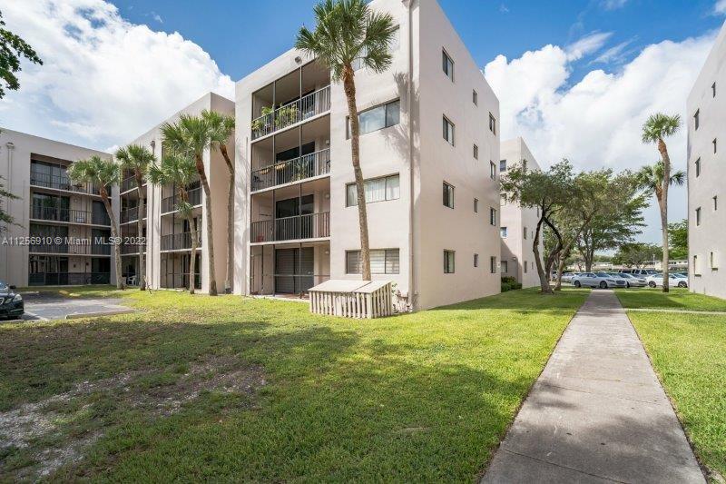 8540 Southwest 133rd Avenue Road, Unit 208 Miami, FL 33183 - Photo 2 of 18 a view of a building with a yard