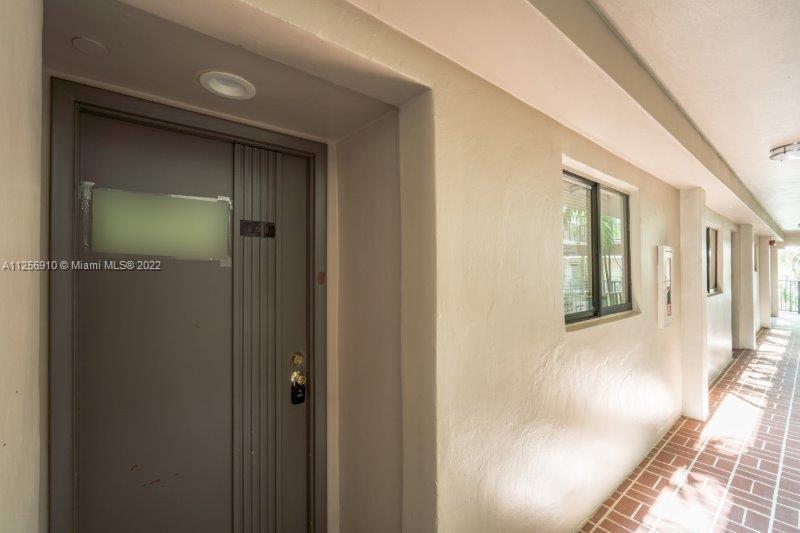 8540 Southwest 133rd Avenue Road, Unit 208 Miami, FL 33183 - Photo 3 of 18 a view of a hallway with wooden floor and staircase