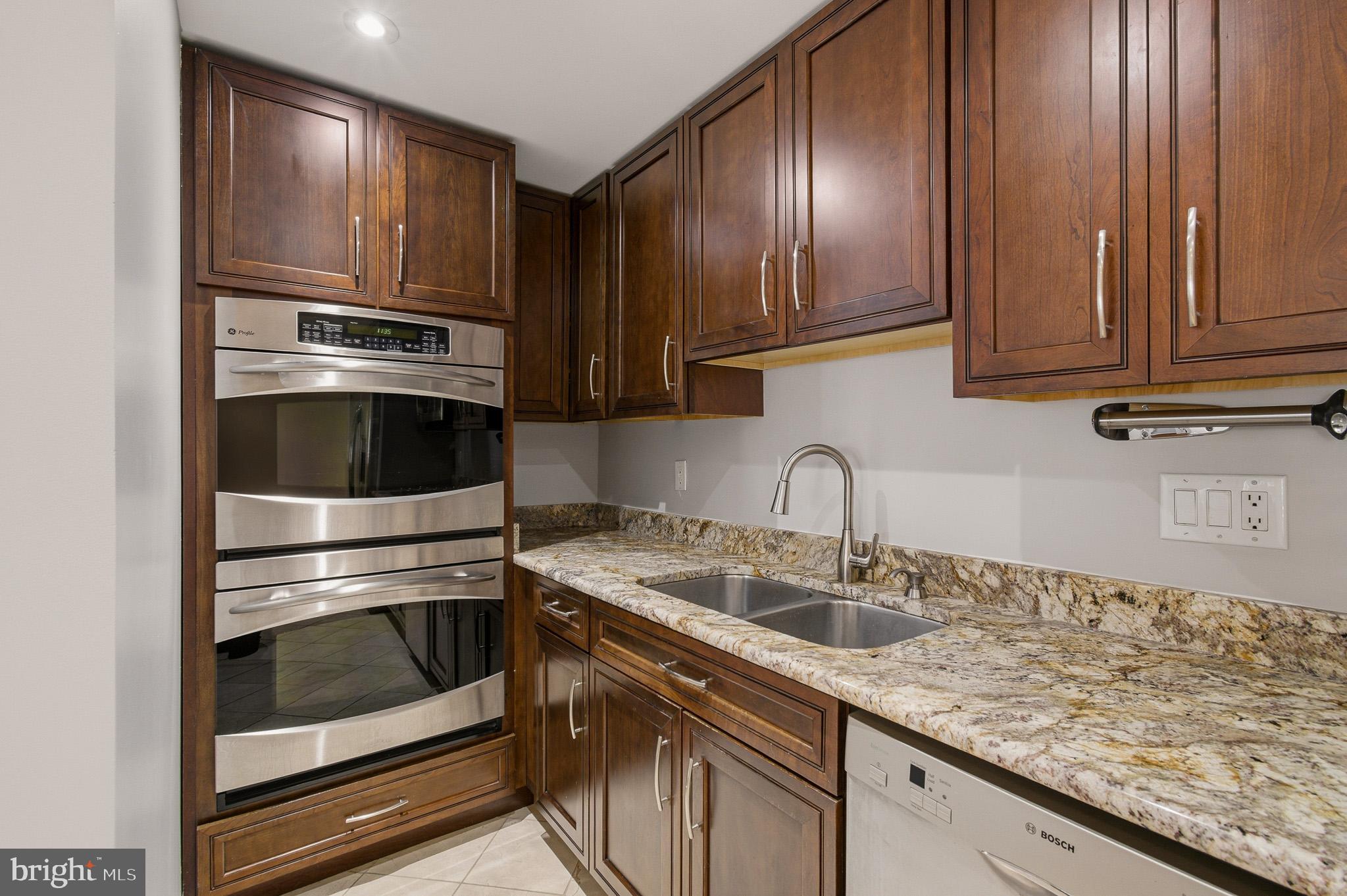 2117 S Street Northwest Washington, DC 20008 - Photo 40 of 63 a kitchen with granite countertop stainless steel appliances and cabinets