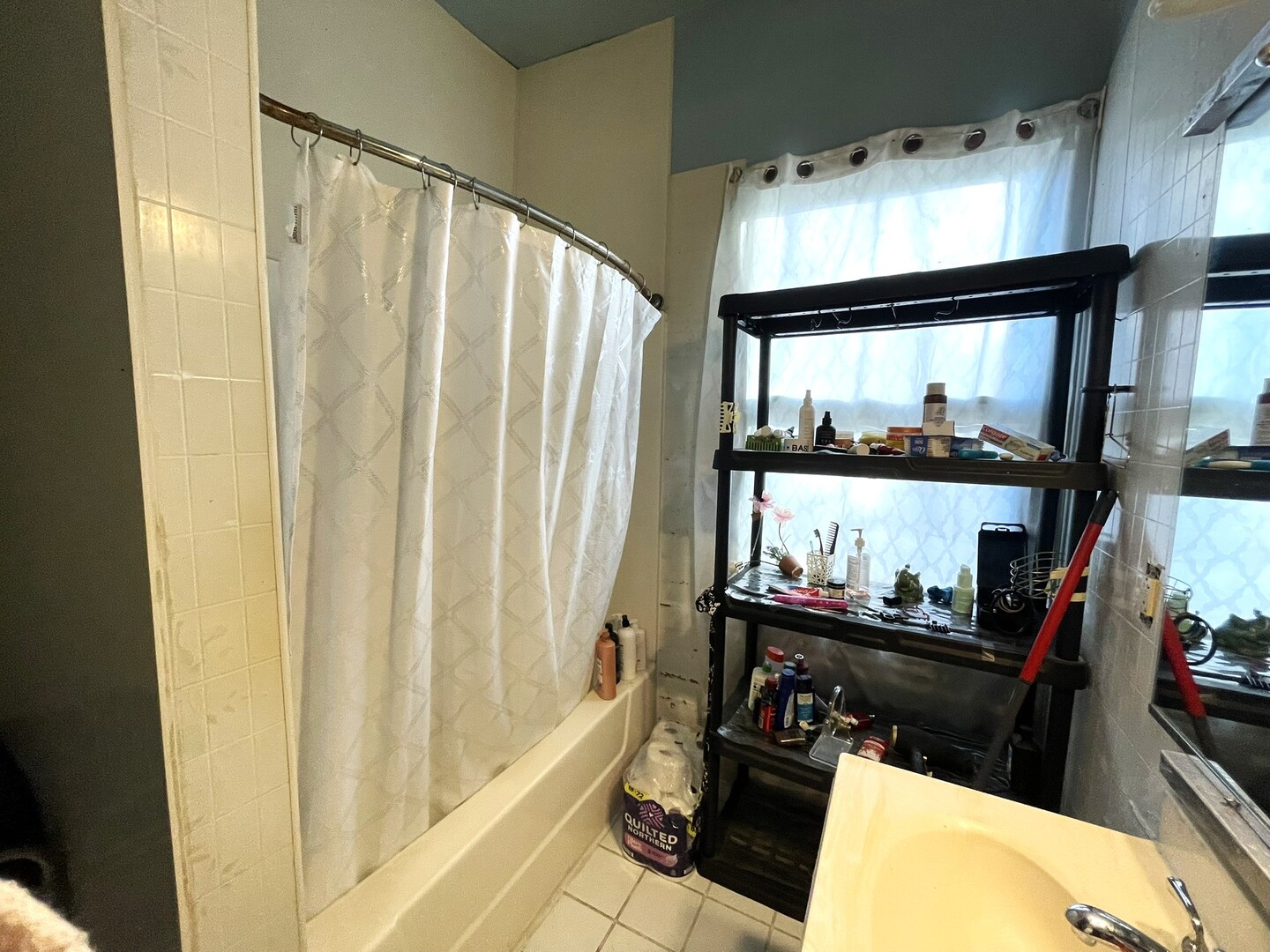 347 Pine Street Joliet, IL 60435 - Photo 31 of 38 a bathroom with a sink a mirror and a shower curtain