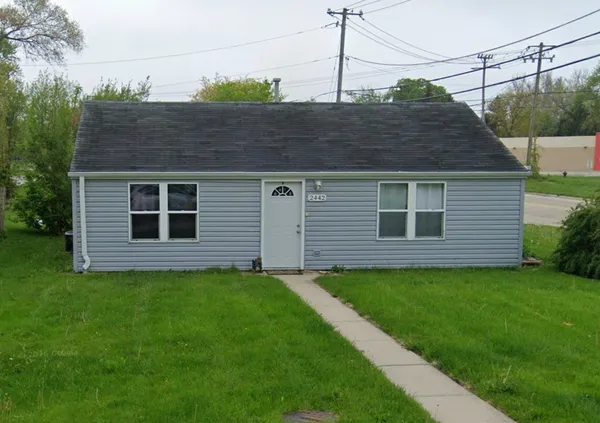 a aerial view of a house next to a yard