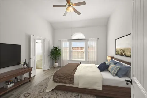 a bedroom with a bed and a flat screen tv