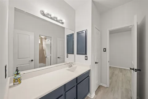 a bathroom with a sink vanity granite and a mirror