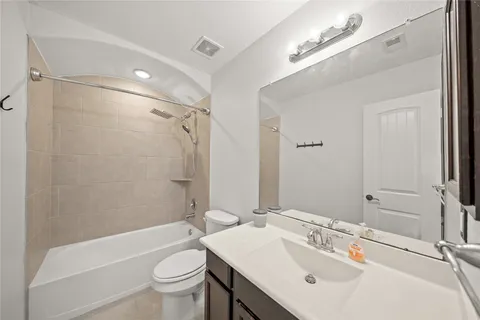 a bathroom with a sink mirror toilet and bathtub