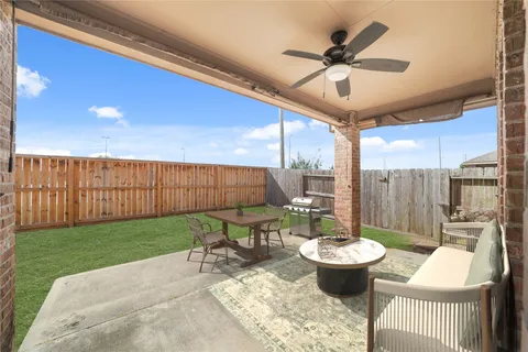 a view of a patio with a dining table and chairs