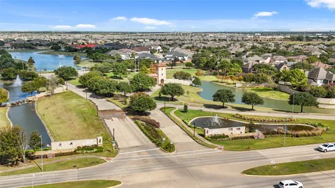 an aerial view of residential houses with outdoor space and swimming pool