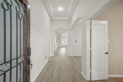 a view of hallway with wooden floor