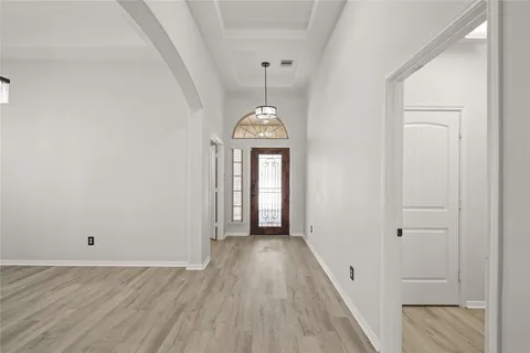 a view of a hallway with wooden floor and a hallway