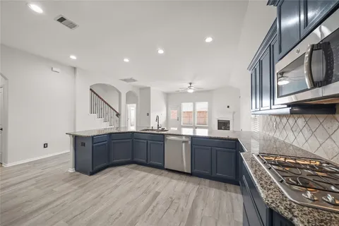 a kitchen with stainless steel appliances granite countertop a stove and a sink