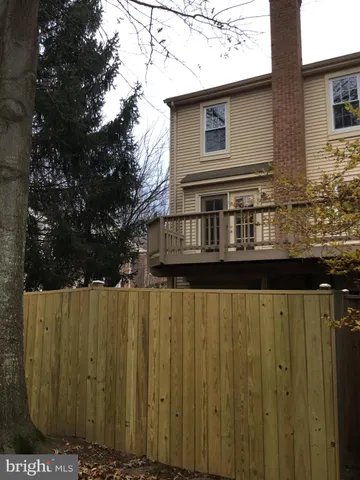 a view of a wooden house with a wooden fence