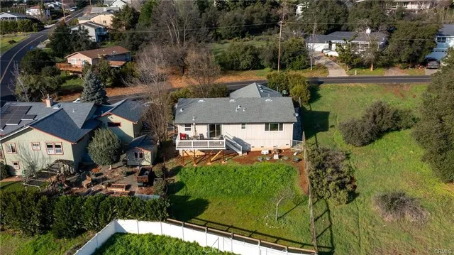 an aerial view of a house with a yard basket ball court and outdoor seating