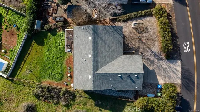 an aerial view of a house with a yard