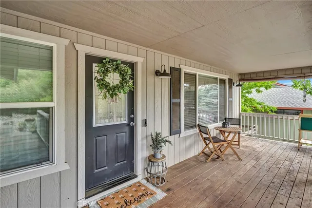 a balcony with chairs and wooden floor
