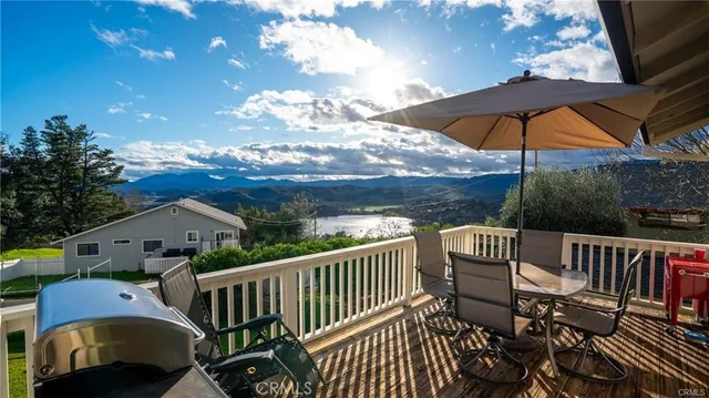 a view of a deck with furniture and a yard