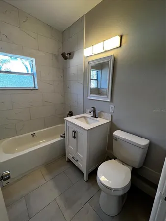 a bathroom with a sink toilet and bathtub