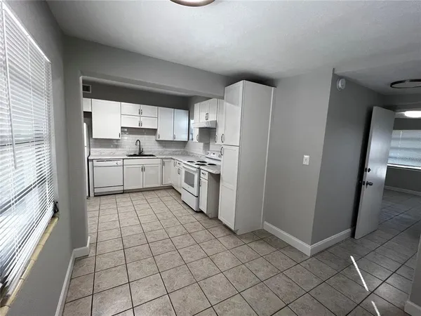 a kitchen with a cabinets and appliances
