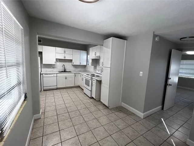 a kitchen with a cabinets and appliances