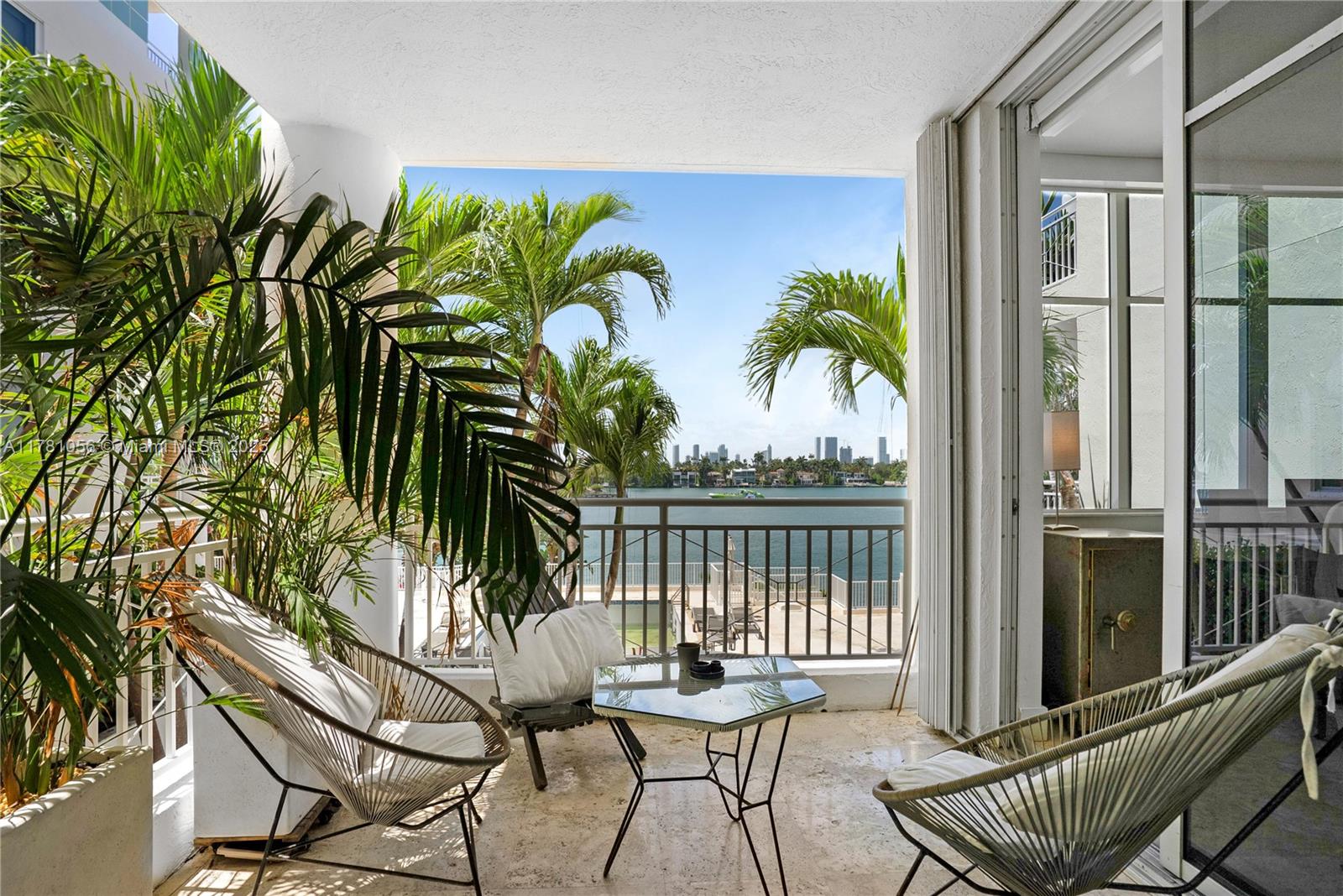 1 Century Lane, Unit 309 Miami Beach, FL 33139 - Photo 1 of 18 a view of a chairs and table in patio with wooden fence