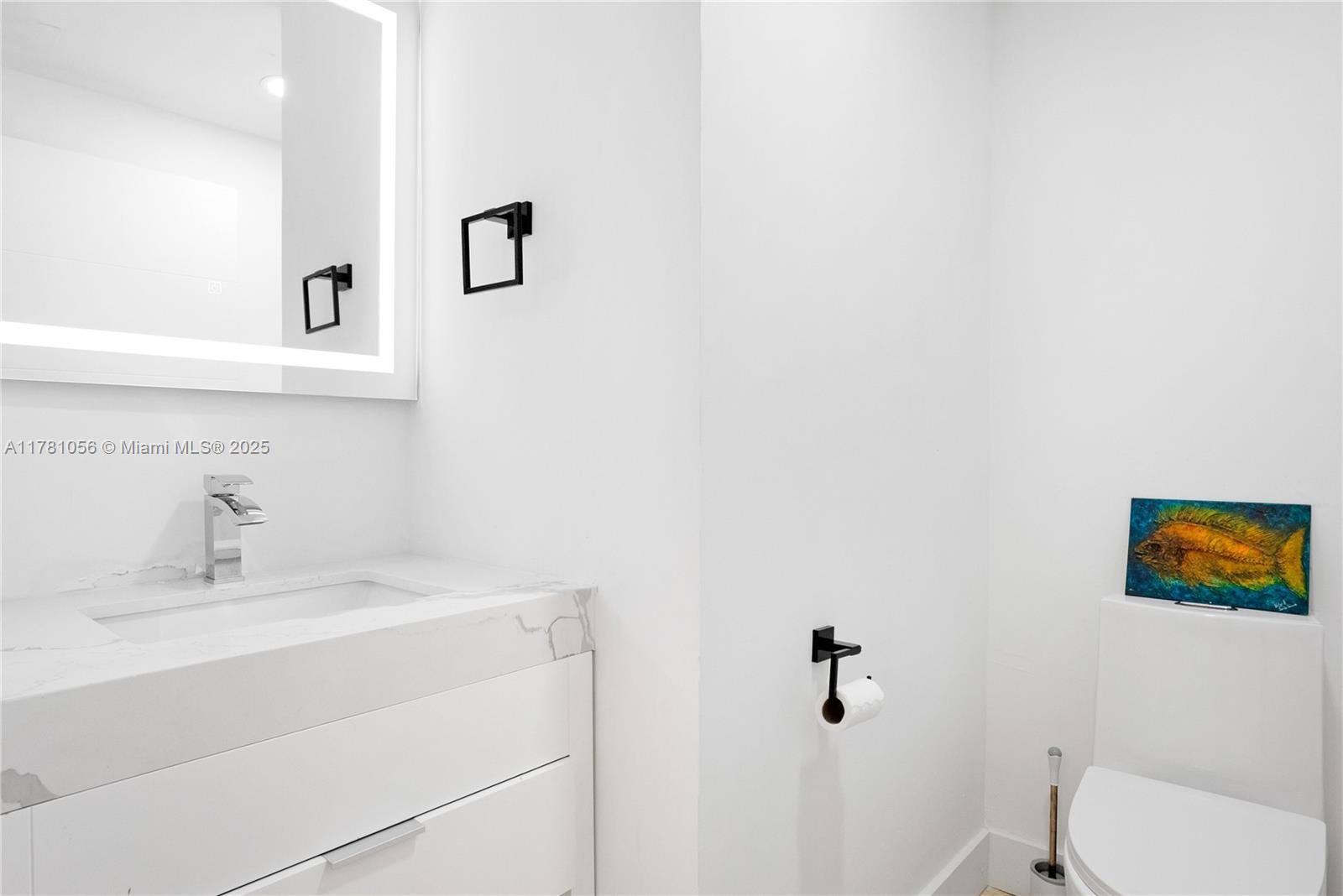 1 Century Lane, Unit 309 Miami Beach, FL 33139 - Photo 17 of 18 a bathroom with a sink and a toilet