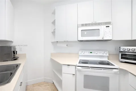 a kitchen with a stove and a microwave