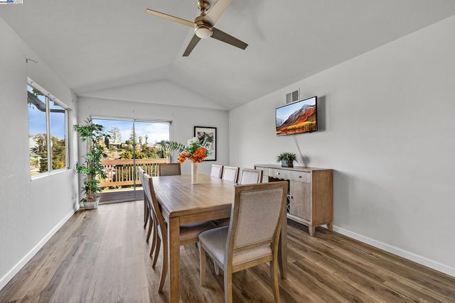 a view of a dining room with furniture and a window