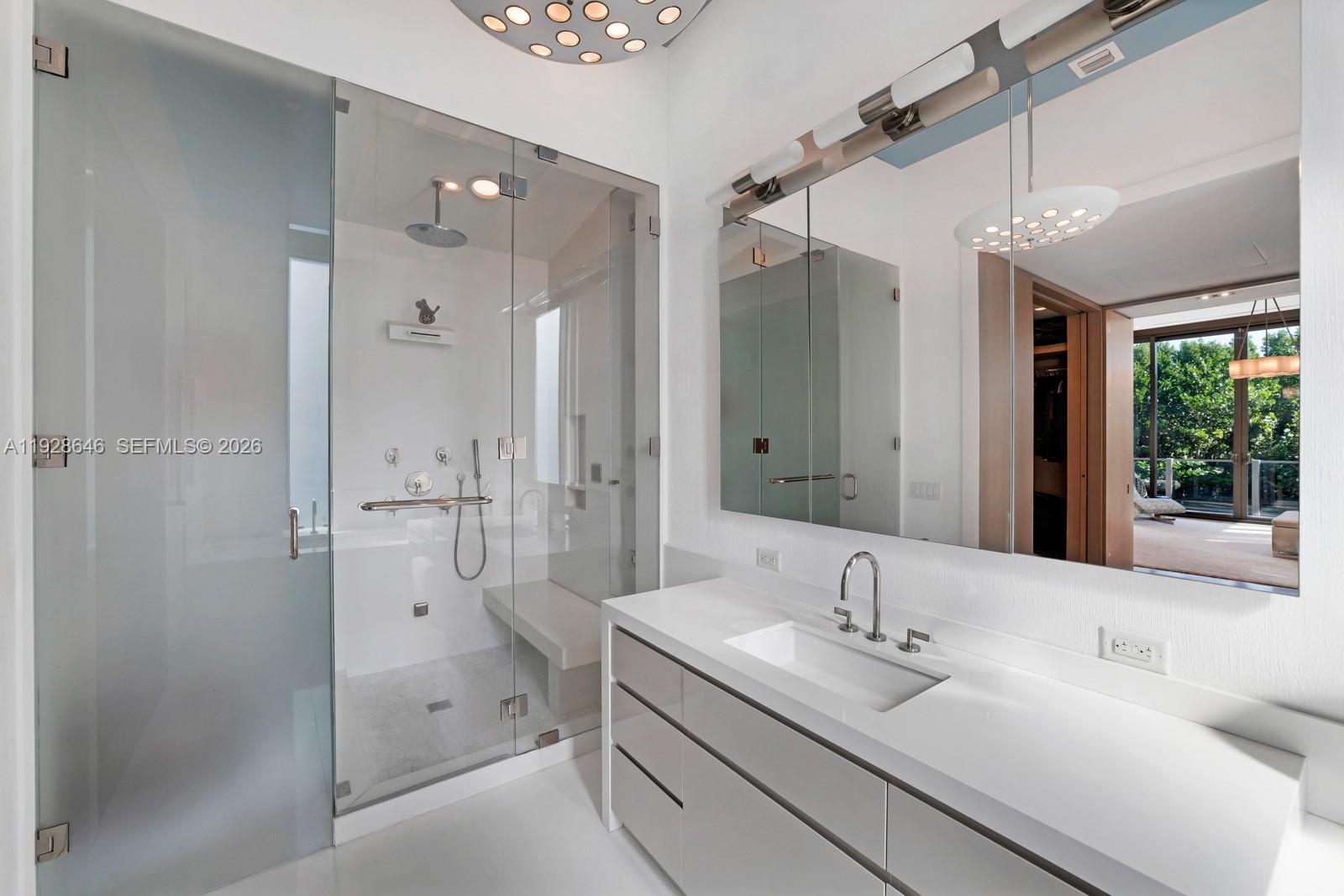 111 Reef Lane Key Biscayne, FL 33149 - Photo 14 of 26 a bathroom with a double vanity sink mirror and shower