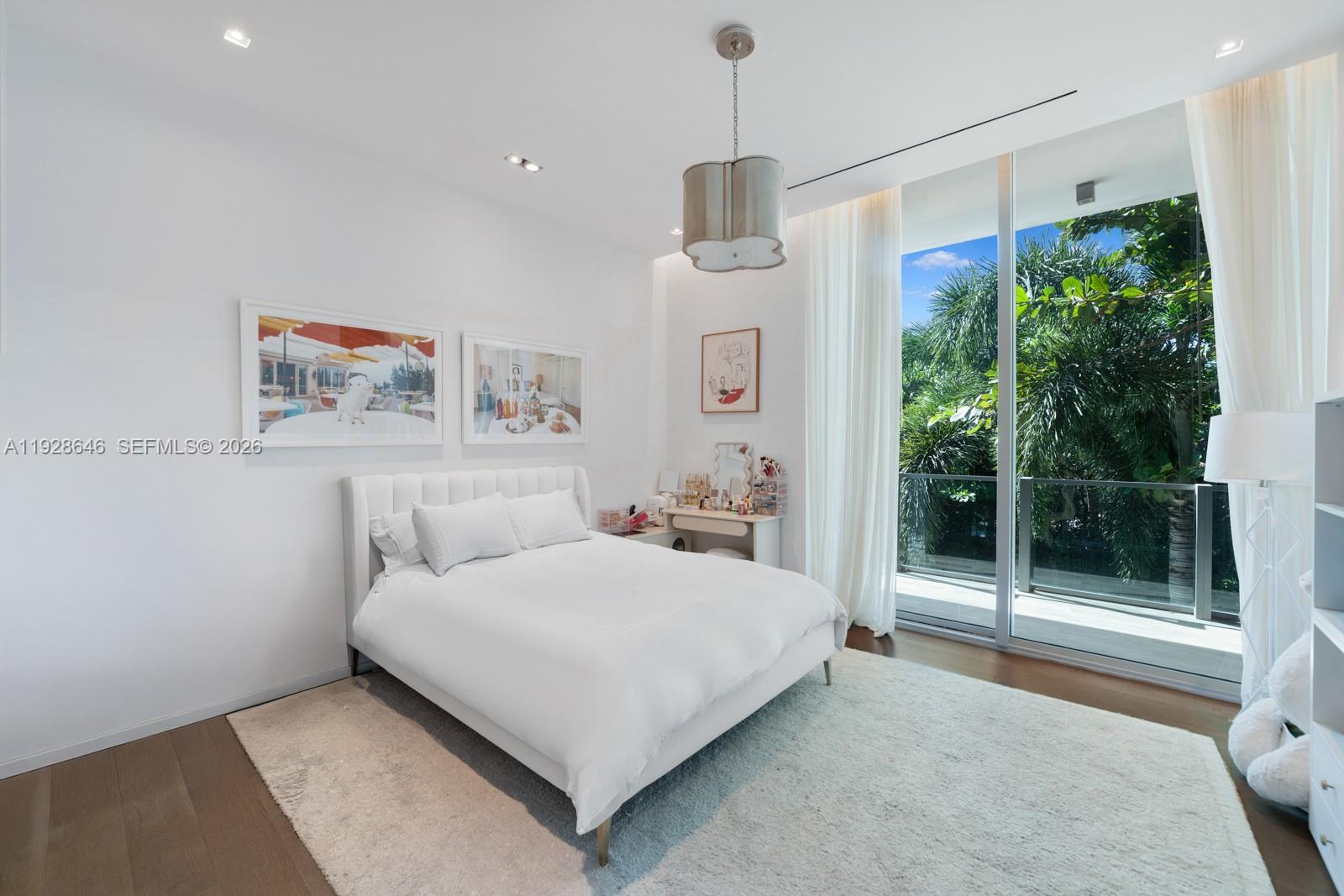 111 Reef Lane Key Biscayne, FL 33149 - Photo 17 of 26 a bedroom with a bed and a painting on the wall