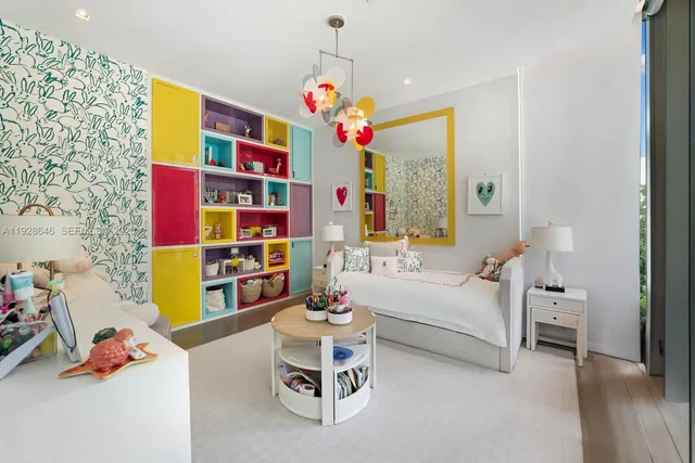 a living room with furniture toys and a chandelier