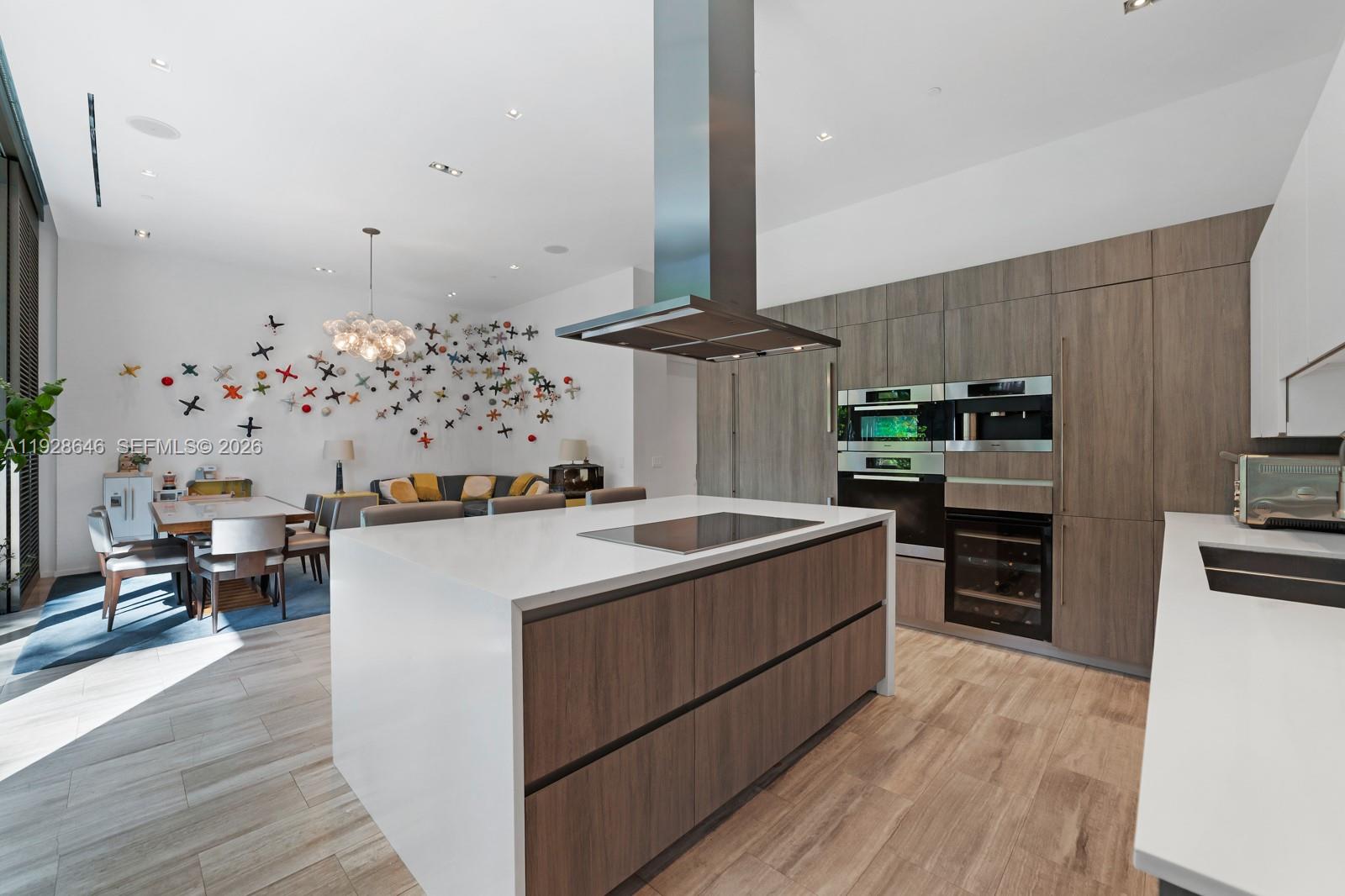 111 Reef Lane Key Biscayne, FL 33149 - Photo 7 of 26 a kitchen with stainless steel appliances a stove top oven a sink dishwasher and a refrigerator