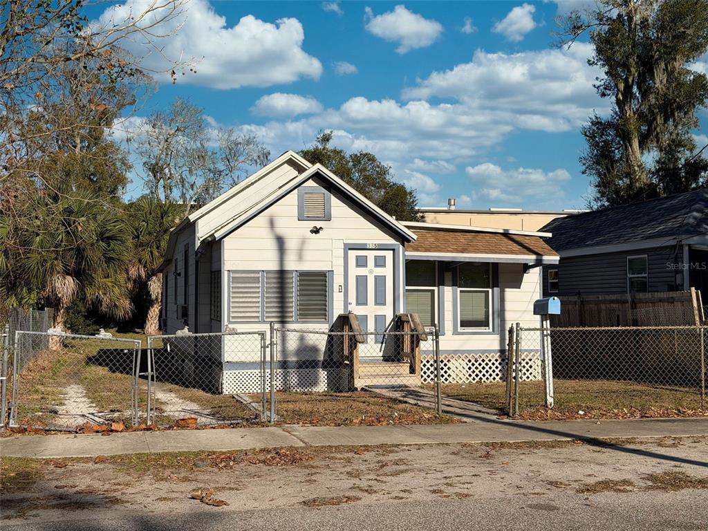 335 Maple Street Daytona Beach, FL 32114 - Photo 2 of 13 a view of a house with wooden walls and a yard