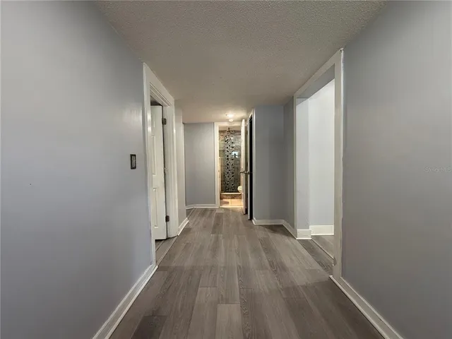 a view of hallway with wooden floor
