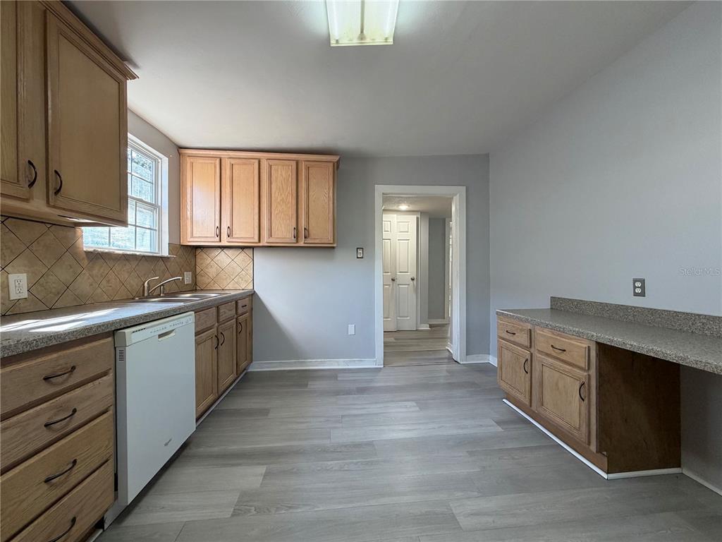 335 Maple Street Daytona Beach, FL 32114 - Photo 9 of 13 a kitchen with granite countertop a stove and a sink