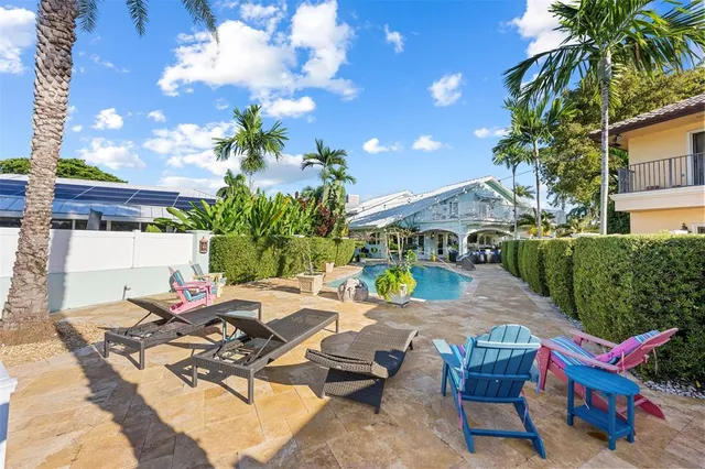 a view of backyard of house with seating space