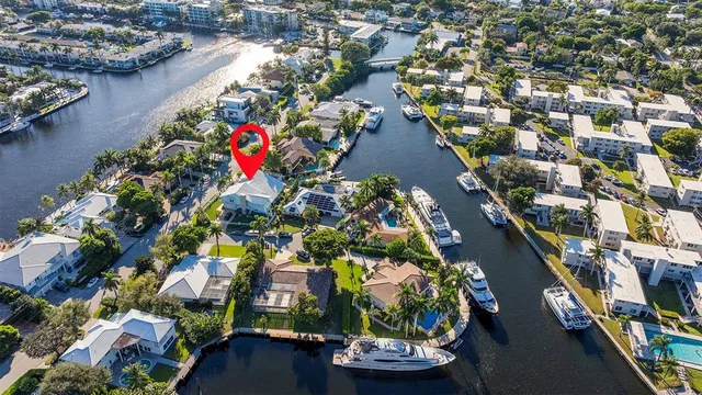 an aerial view of lake and residential houses with outdoor space