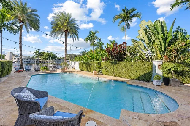 a view of a backyard with plants and a patio